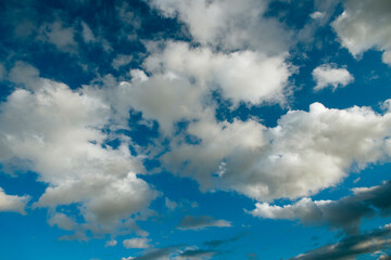 Fluffy white clouds against a vibrant blue sky.