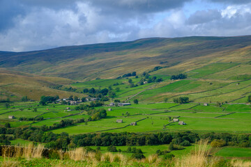 First signs of autumn in the view over Raydale and Marsett village in the Yorkshire Dales