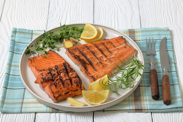 grilled salmon fish fillet with herbs, top view