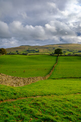 Sunshine through the rain clouds in the landscape near Hawes in Wensleydale, Yorkshire, UK