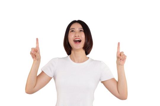 portrait of a Happy Asian woman smiling points her index finger at an empty space in the background and looks straight ahead on white background