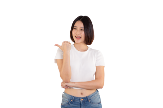 portrait of a Happy Asian woman smiling points her index finger at an empty space in the background and looks straight ahead on white background