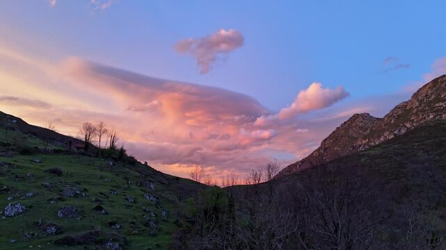 Drone flight over a spectacular landscape in the mountains of Quiros in Asturias, Spain with a sky of intense colors at sunset