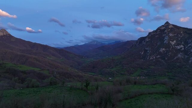 Drone flight over a spectacular landscape in the mountains of Quiros in Asturias, Spain with a sky of intense colors at sunset