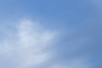 Blue sky and clouds background with lots of copy space.