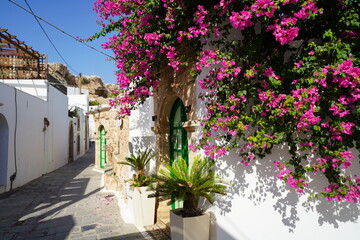 whitewashed houses in the narrow streets of Lindos, floral decoration
