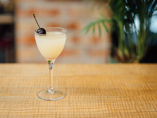 A classic gin-based cocktail with Chartreuse liqueur, Maraschino liqueur, and fresh lime juice, garnished with a cherry on top.