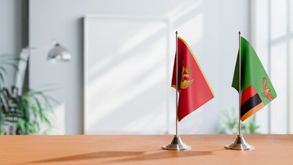 FLAGS OF MONTENEGRO AND ZAMBIA ON TABLE