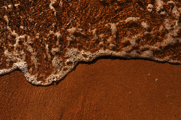 Soft sea wave rolls onto sandy beach. Red Sea. Copy space.