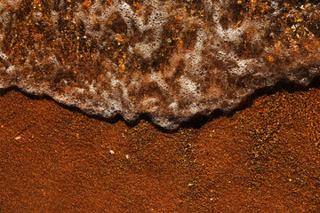 Soft sea wave rolls onto sandy beach. Red Sea. Copy space.