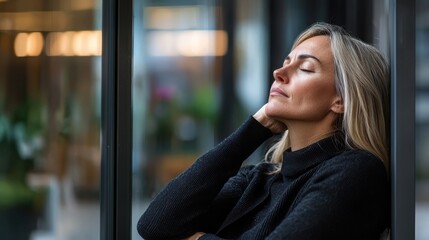 Fototapeta premium Overcoming burnout a businesswoman's reflection in a tranquil workspace environment with glass windows