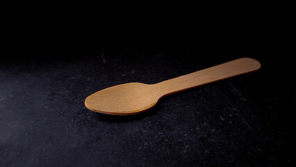 wooden spoon on a black background.