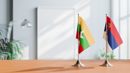 FLAGS OF MYANMAR AND SERBIA ON TABLE