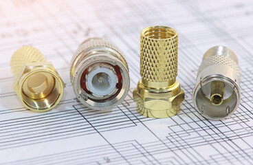 Metal F-connectors for connecting coaxial cable. Close-up. Soft focus.