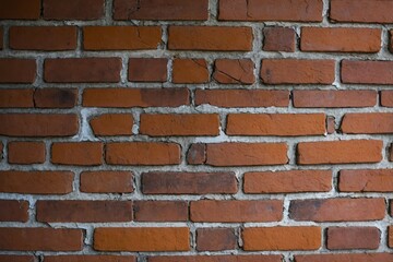 Fototapeta premium Cracks in a brick wall. Background or backdrop with copy space