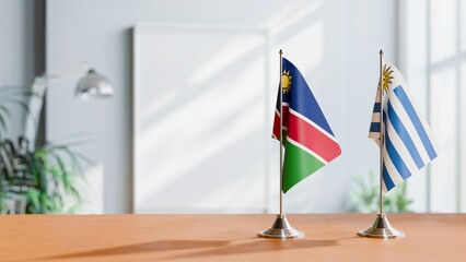FLAGS OF NAMIBIA AND URUGUAY ON TABLE