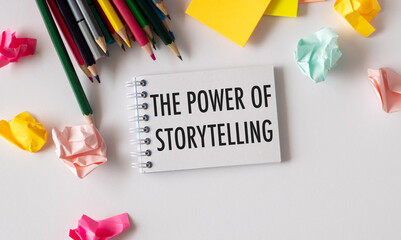 Holding a card with text THE POWER OF STORYTELLING, business concept image with soft focus background.
