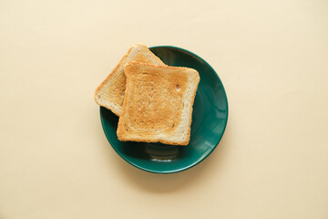 Vegan fried toast on a plate and a hand on a yellow background, healthy eating, healthy breakfast.