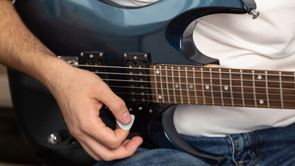 Guitar music. Practice chords. Male performer hands with fingers studying melody of song on...