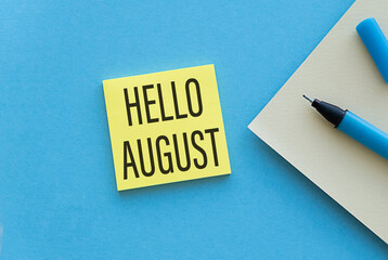Hello August text message with pen on blue background