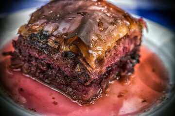 A closeup photo of a tasty and juicy homemade cherry pie on a plate