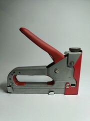 red stapler on white background