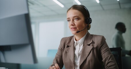 Caucasian woman works in modern office: Female technical support operator or customer manager talks...