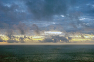 The sky is cloudy and the ocean is calm