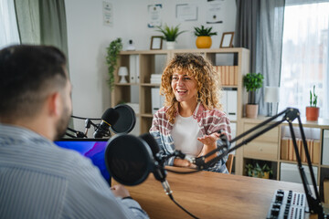 woman host interviewer ask man guest questions while record podcast