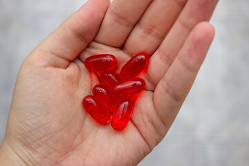 Hand with a bunch of red pills on the center