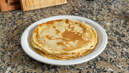 Dish full of delicious thin pancakes