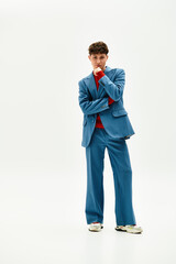 A stylish man in a vibrant blue suit exudes charm and confidence during a photoshoot.