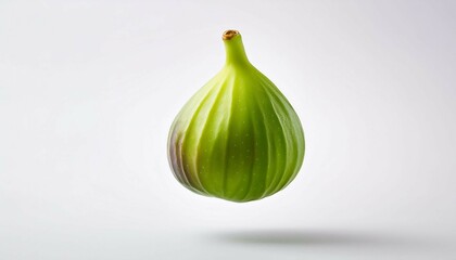 Obraz premium singular green fig suspended mid air against a stark white background capturing its rich texture and vibrant hue with precision and clarity