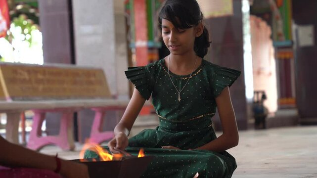 A Hindu family gathered around a sacred fire, performing a Yagya or havan