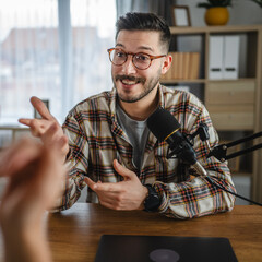 smile man radio host laugh while record podcast with woman colleague