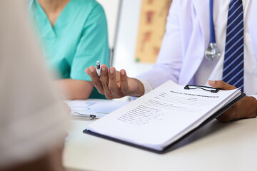 Health consultant from a team of medical experts in the hospital. Doctor talking with patient in examination room at hospital.