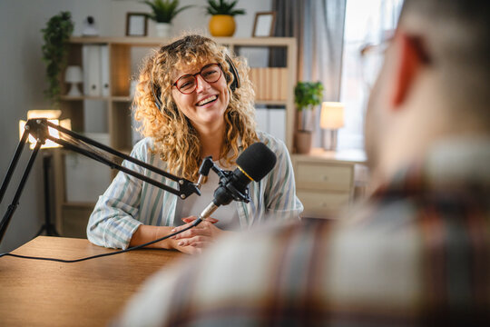 woman radio host laugh while record podcast with man colleague