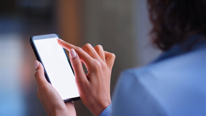 Over The Shoulder Close Up Shot Of Businesswoman Using Blank Screen Mobile Phone