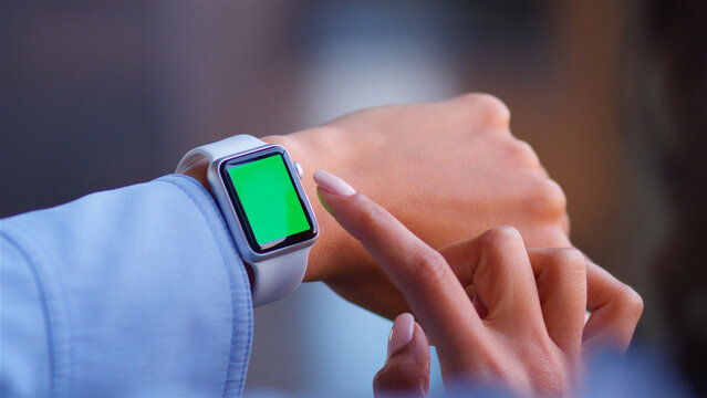 Over The Shoulder Close Up Shot Of Businesswoman Using Green Screen Smart Watch
