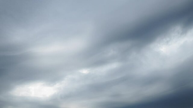 Beautiful white and dark storm clouds in blue sky. Volumetric effect. Convection in troposphere. Time-lapse. Cumulus clouds low-level, puffy, cotton-like. Fluffy Cumulonimbus. Rainy terrible clouds