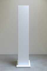 Tall white blank rectangular pedestal isolated on grey background.