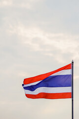 Motion and blur, the Thai flag fluttering atop the flagpole represents the Thai nation that knows love and unity. The colors of the Thai flag represent the nation, religion, and the king.
