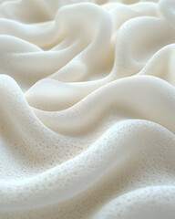 Obraz premium Close-up of soft, white, textured fabric with subtle waves and patterns.
