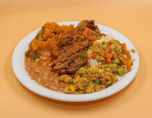 cooked ribs with pumpkin cream, farofa, rice and beans