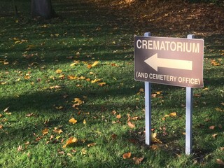 crematorium & cemetery office sign post during autumn