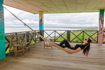 Relaxed woman resting in a hammock in the jungle