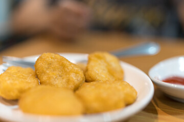 Pile of golden deep fried battered chicken nuggets. Selective focus