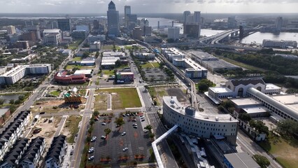 Fototapeta premium Jacksonville, Florida city skyline beside St. Johns river downtown office buildings and streets working and living in coastal town in morning light as storm front passes over