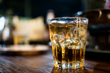 Ice cube whiskey glass on wood table