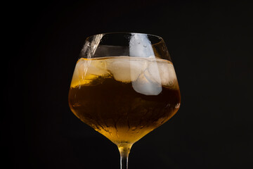 transparent glass with cold apple juice with ice